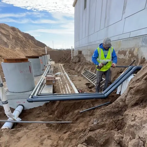 Worker installing reclaim tanks at a business